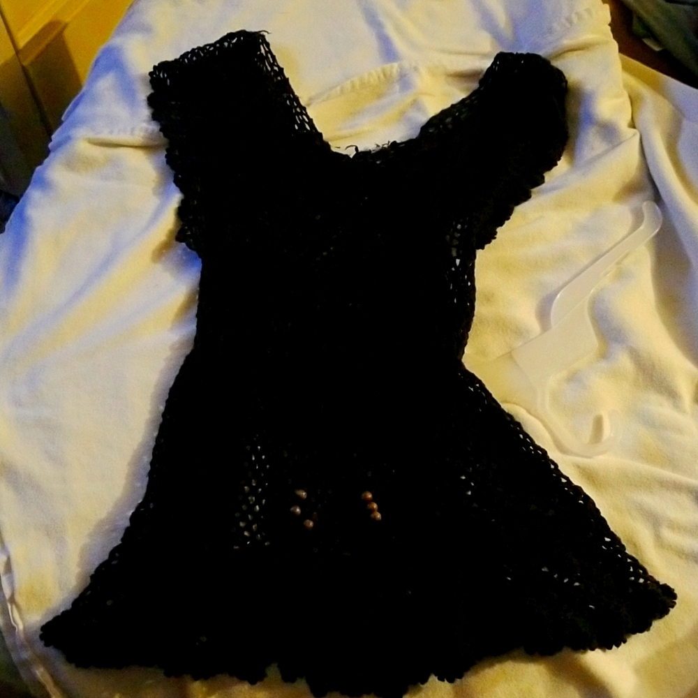 Black crochet cover up over a tank or bathing suit